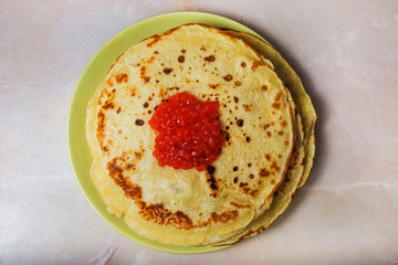 pancakes on a plate with red caviar