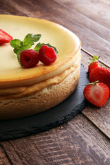 Homemade cheesecake with fresh strawberries and mint for dessert