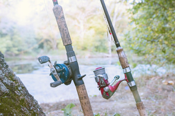 Two fishing rods with reels. One reel spinning and second baitcasting reel