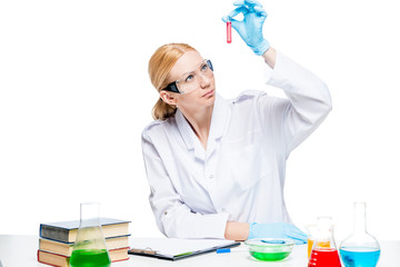 Specialist chemist biologist with test tubes at the table makes experiments