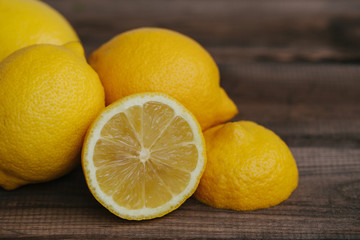 Yellow lemon fruits on wooden table.
