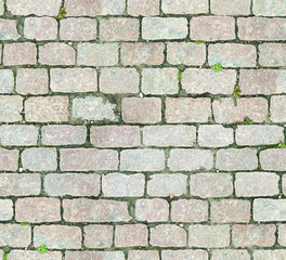Stone pavement texture. Granite cobblestoned pavement background. Abstract background of old cobblestone pavement close-up. Seamless texture. Perfect tiled on all sides