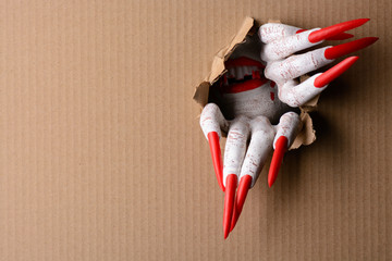 Vampire tearing through cardboard with sharp claws