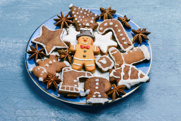Gingerbread cookies on a plate on a blue wooden background