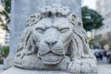 lion head statue city environment squinning eyes strength calm guard