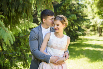 Fototapeta premium Portrait of a happy young couple in love and giving a kiss