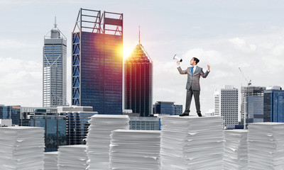 Businessman standing with megaphone.