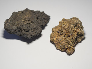 close up ochre and beige gray natural lava stones on white background