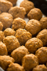 Homemade raw minced meat meatballs on the baking tray