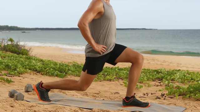 Fitness man doing Pulse Lunges exercise. Male fitness model doing Lunge Pulses workout while exercising on beach working out glutes, hamstrings and quadriceps. Left leg.