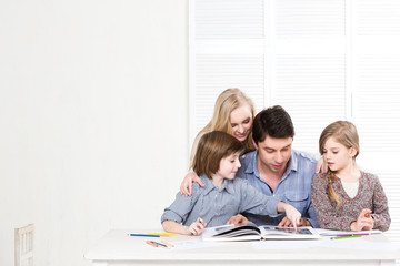 Fototapeta premium Happy family. Parents and children are engaged together.