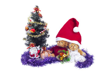 Plush bear cubs near an artificial Christmas tree with Santa Claus