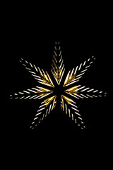 Photo of a golden star with light bulbs on a black background