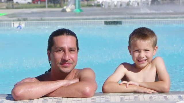 Portrait of father and son in the pool