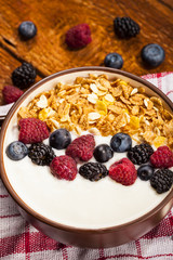 A bowl of healthy and delicious smoothie with grains and fresh berry frui