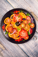 Tomato, basil, parsley, dill and onion salad. View from above, top studio shot, vertical