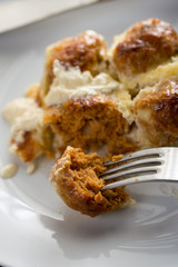 Closeup macro of sliced meatballs with cheese served on the plate