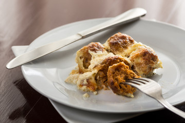 Closeup macro of sliced meatballs with cheese served on the plate