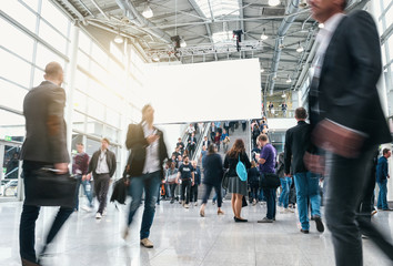 blurred business people at rush hour at a trade fair