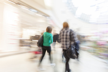 Shopper walking in front of shop window