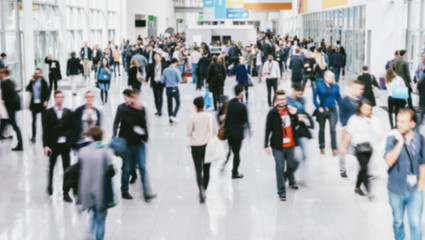 anonymous blurred people walking in a modern hall of a Exhibition