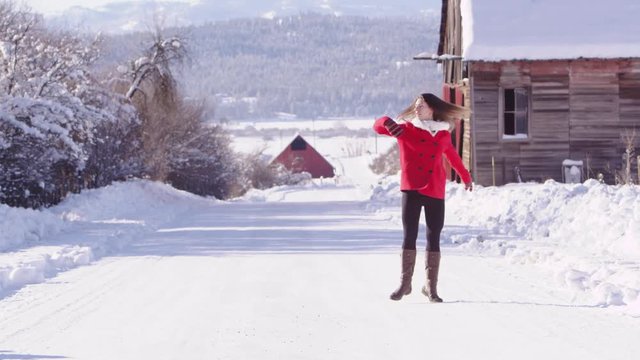 Slow motion woman dancing in the snow