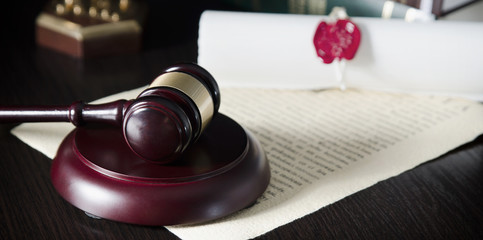 Law gavel in courtroom. Legal system.