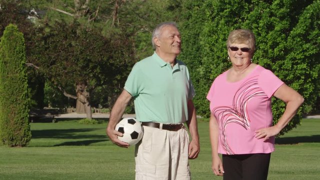 Portrait of elderly couple with soccer ball