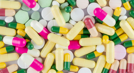 Fototapeta na wymiar many colored drugs pills shapes texture background