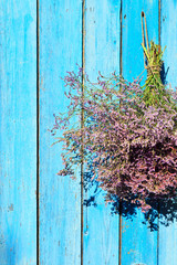 bouquet hanging on a wooden blue wall