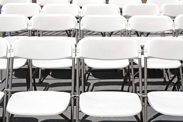 White folding chairs in rows