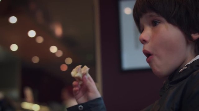 4K Child Eating in a Cafe and Looking at Lights