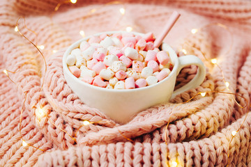 A cup of coffee wrapped in warm plaid.  Holiday concept. Flat lay, top view