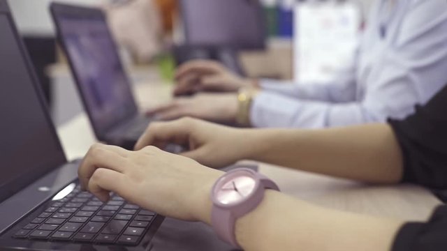 The operator of the hotline with headsets, sit at the computer in the office and advise clients. Workers call-center, a woman talking to customers. She prints on the computer and answers questions.