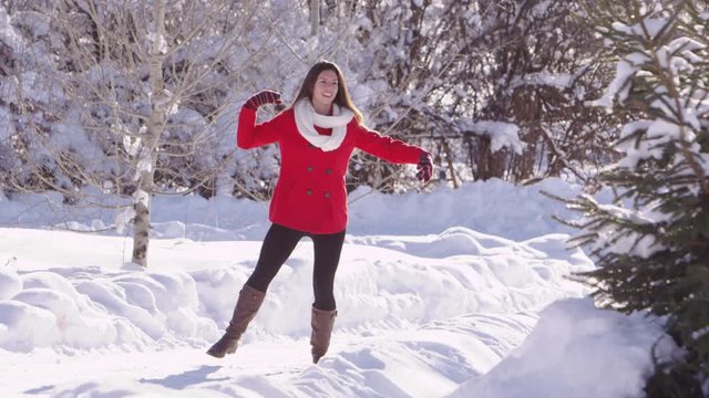Slow motion woman dancing in the snow