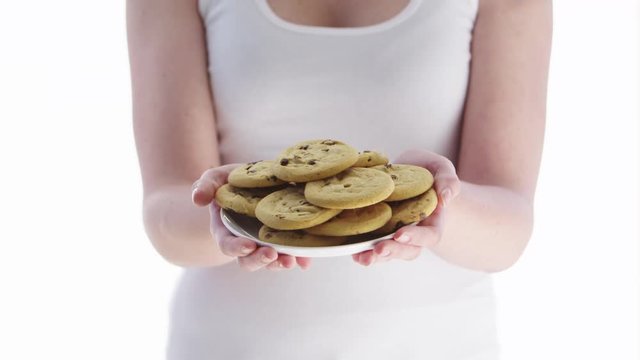 Woman holding chocolate chip cookies