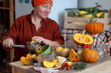 Woman cooking pumpkin at her kitchen