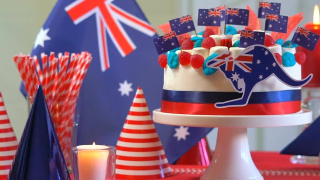 HD Australian celebration party table with showstopper cake decorated with candy, stars and flags, dolly slider close up.