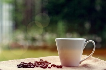 Morning coffee closeup outdoor garden blur background