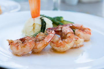 grilled shrimps or shrimps skewer on plate with green salad