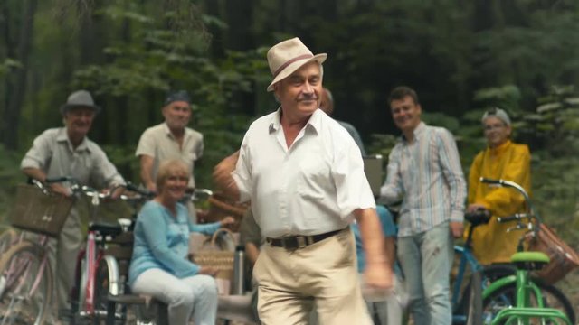 Old man dances in the park