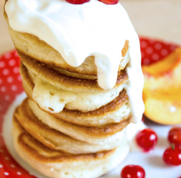 Pancakes with sour cream. Selective focus. Top view.