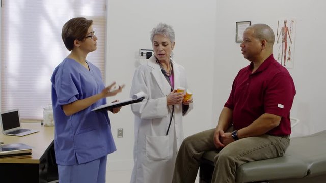 Doctor and nurse explaining medications to patient