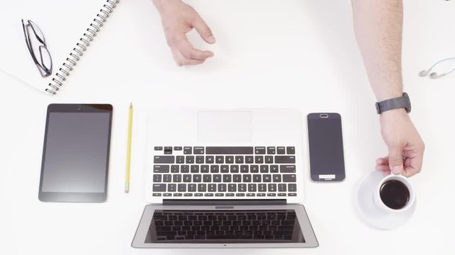 Top view of laptop, cellphonem, tablet and work desk
