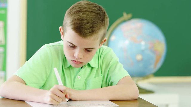 Young boy writing and taking notes