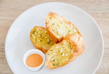 Garlic and herb bread on wooden table