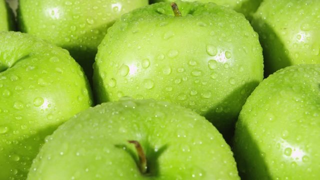 Rotating closeup view of green apples