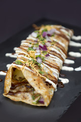 Grilled Tortilla Wrap Topped with Onions, Herbs, and White Sauce