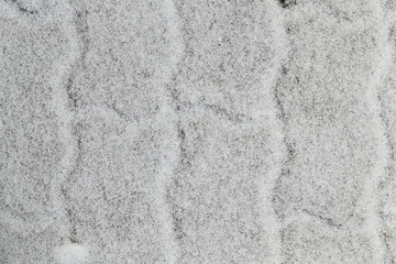 snow-covered sidewalk tile