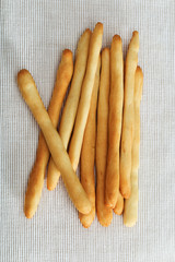 Italian breadsticks on light fabric. Vertical format